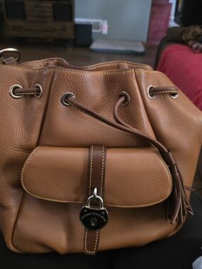 Tan Leather Drawstring Bucket Bag with Front Pocket and Tassel